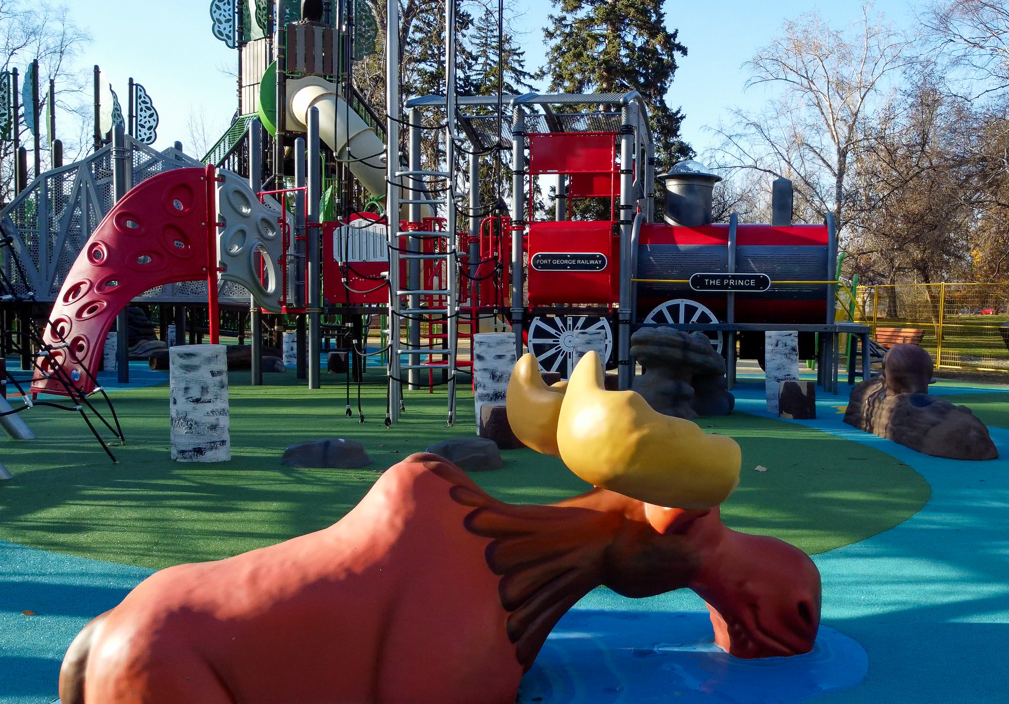 Moose and Little Prince playground equipment at Lheidli T'enneh Memorial Park playground on a sunny fall day