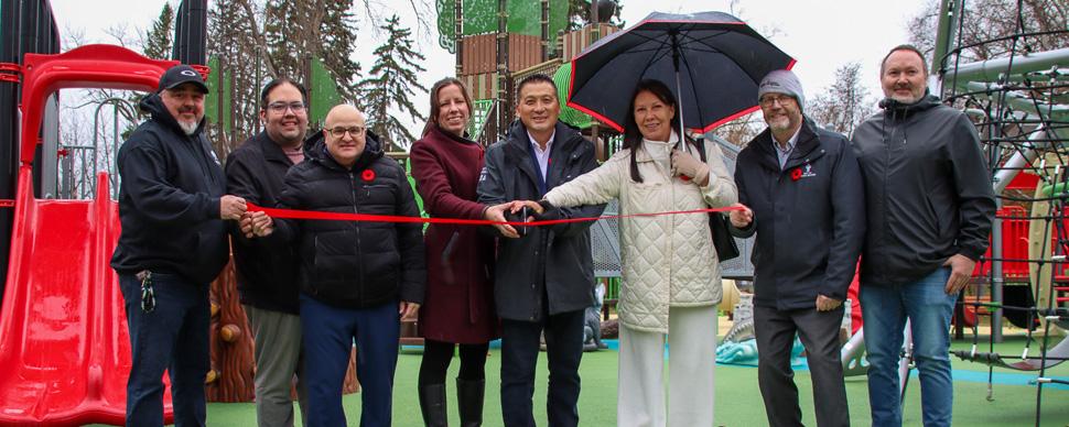 Representatives from the City of Prince George, Lheidli T'enneh, and Northern Development Initiatives Trust cutting the ribbon to open the new playground at Lheidli T'enneh Memorial Park