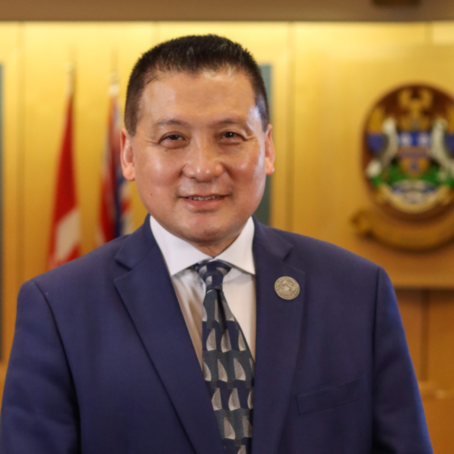 A closeup photo of Mayor Simon Yu, taken in Council Chambers at City Hall
