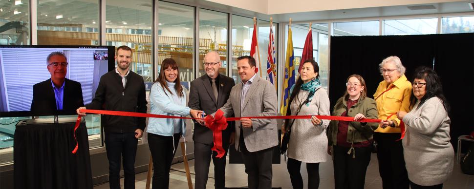 City and Lheidli T'enneh Councillors and Canfor rep cutting a ribbon at Canfor Leisure Pool opening