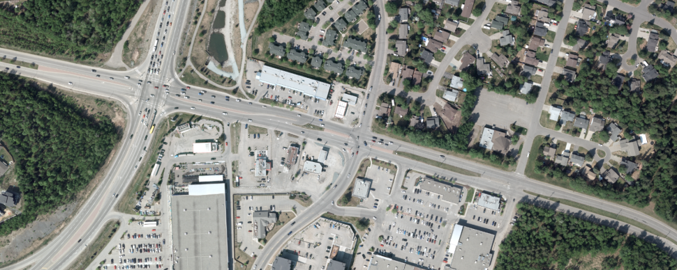 An aerial view of Domano Blvd and Highway 16. Includes streets, parking, residences, and businesses.