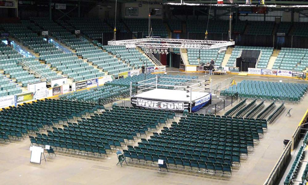 Chairs and a stage being set up at the CN Centre for a WWE event.